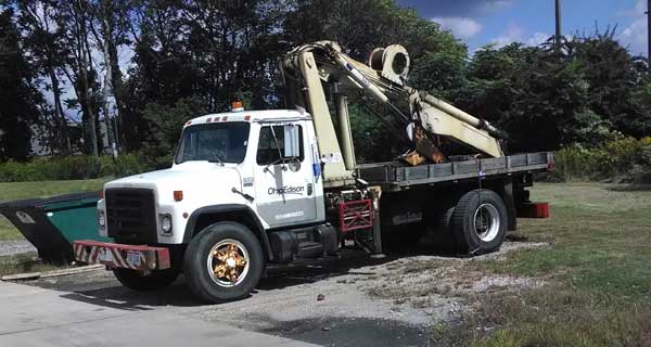 repairs and crane inspections being done on crane truck by service mechanics technians