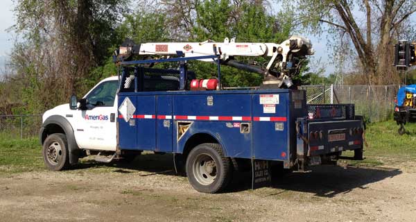 repairs and crane inspections being done on crane truck by service mechanics technians