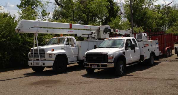 repairs and crane inspections being done on crane truck by service mechanics technians