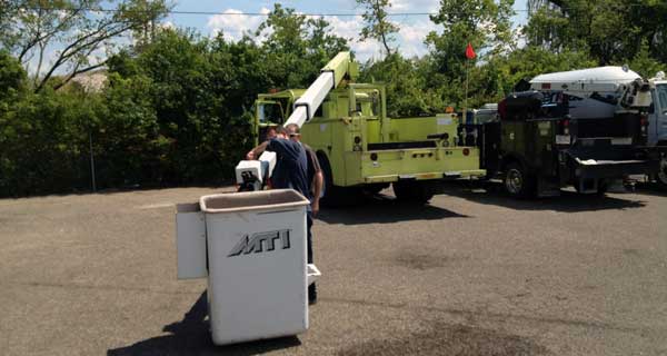 repairs and crane inspections being done on crane truck by service mechanics technians