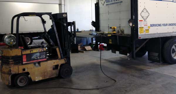 repairs and crane inspections being done on crane truck by service mechanics technians