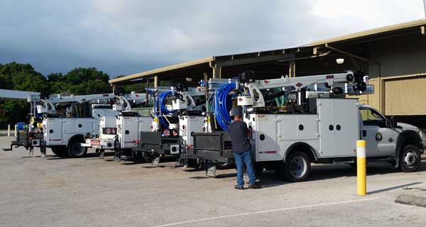 repairs and crane inspections being done on crane truck by service mechanics technians