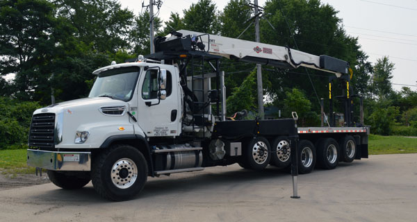 repairs and crane inspections being done on crane truck by service mechanics technians