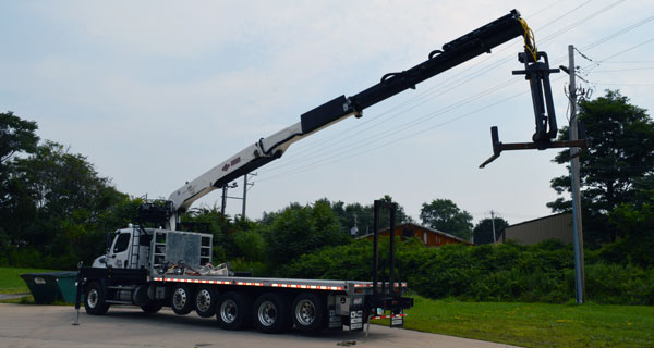 repairs and crane inspections being done on crane truck by service mechanics technians